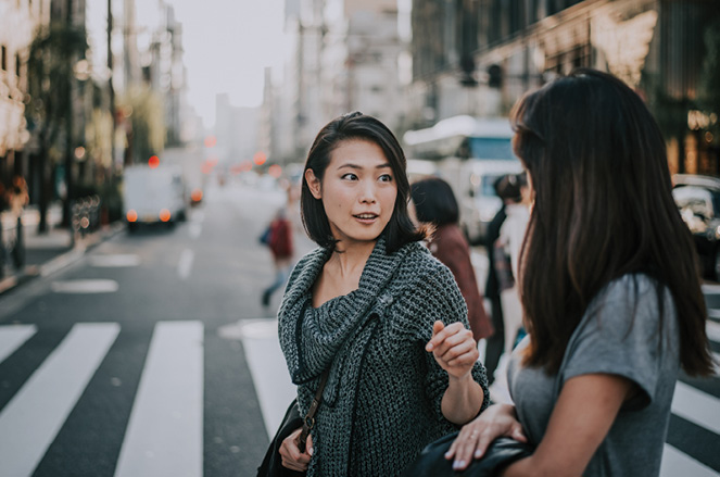 Two japanese women around in Tokyo during daytime.