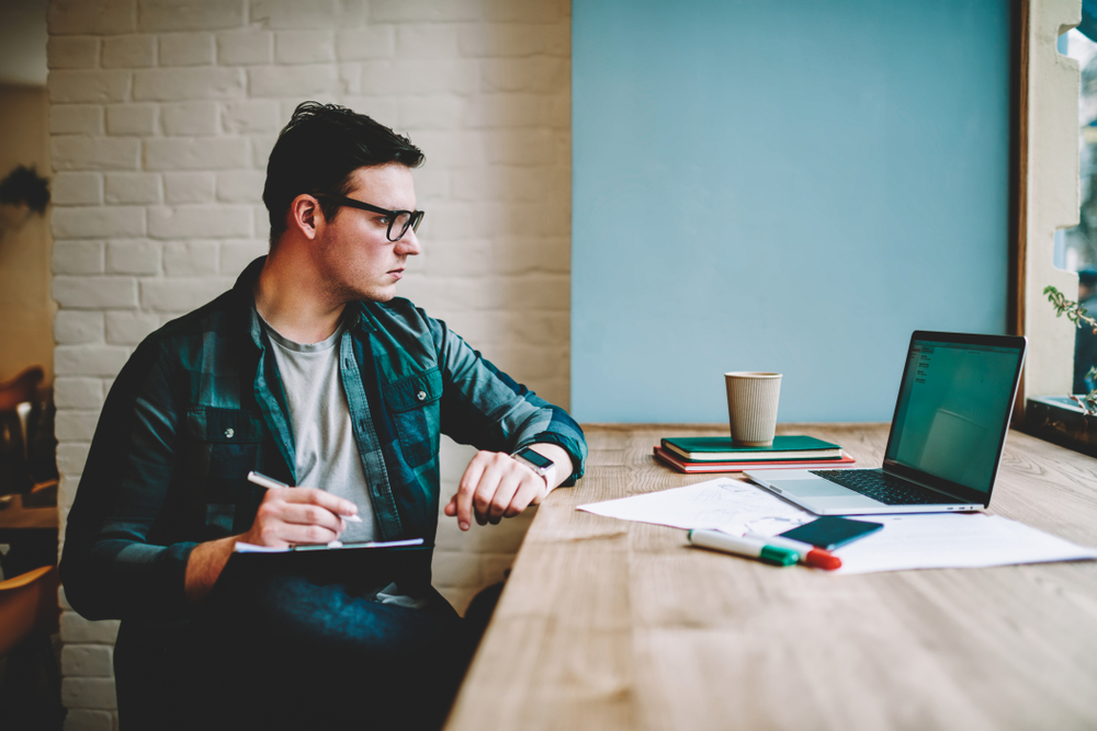 Pensive,Hipster,Guy,In,Eyewear,Watching,Training,Webinar,On,Laptop